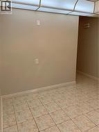 Neutral-toned walls complement the square tile flooring -