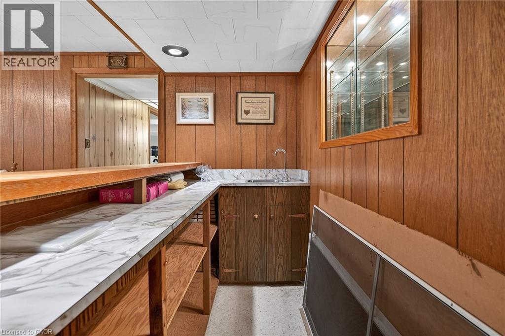 Bar area with light countertops, wood finish cabinetry, and wooden walls - 21 Bluebird Avenue, Hamilton, ON