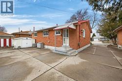 Back of property with a shed and brick siding -