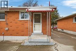 View of exterior entry with brick siding -