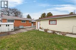 Back of property with a lawn and a patio -