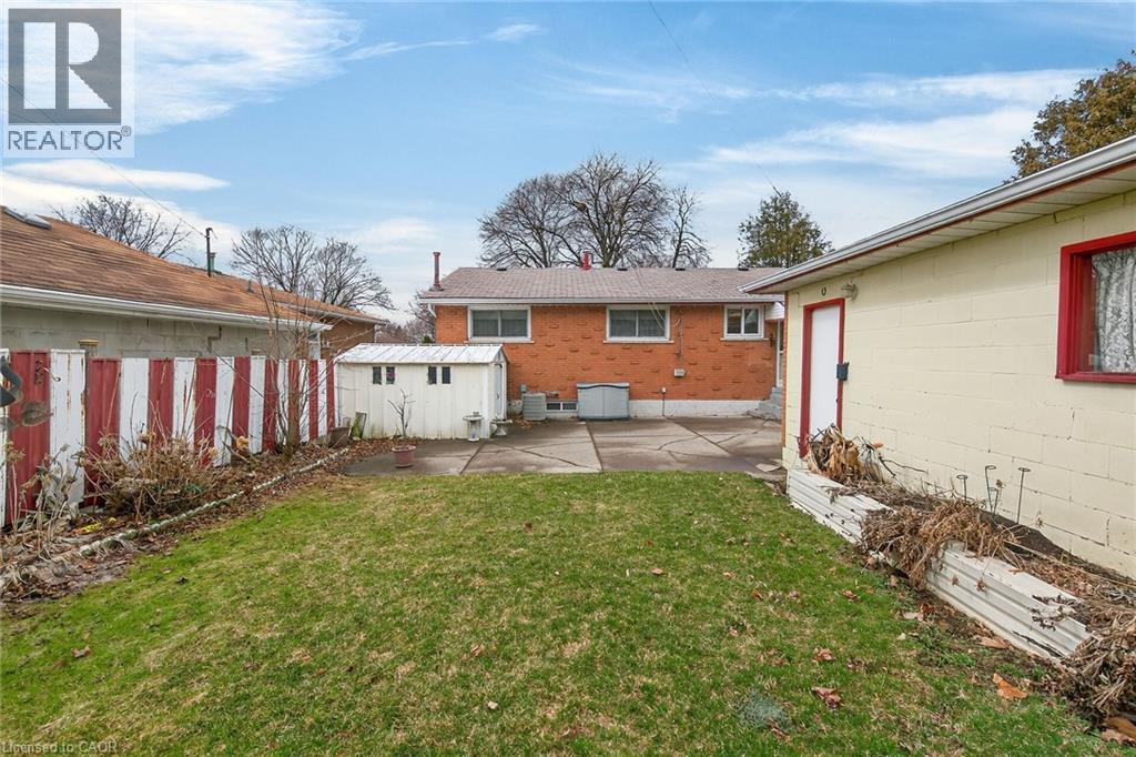Rear view of house featuring a patio and a storage shed - 21 Bluebird Avenue, Hamilton, ON