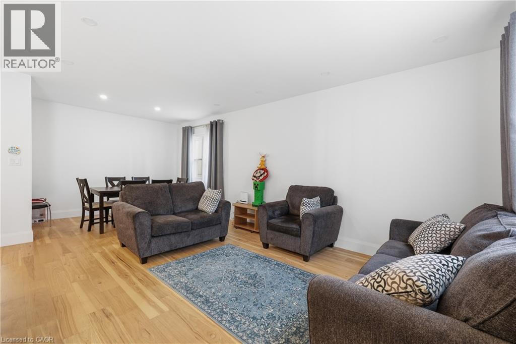 Living room featuring light wood finished floors and recessed lighting - 129 Jackson Street W, Hamilton, ON - Indoor Photo Showing Living Room
