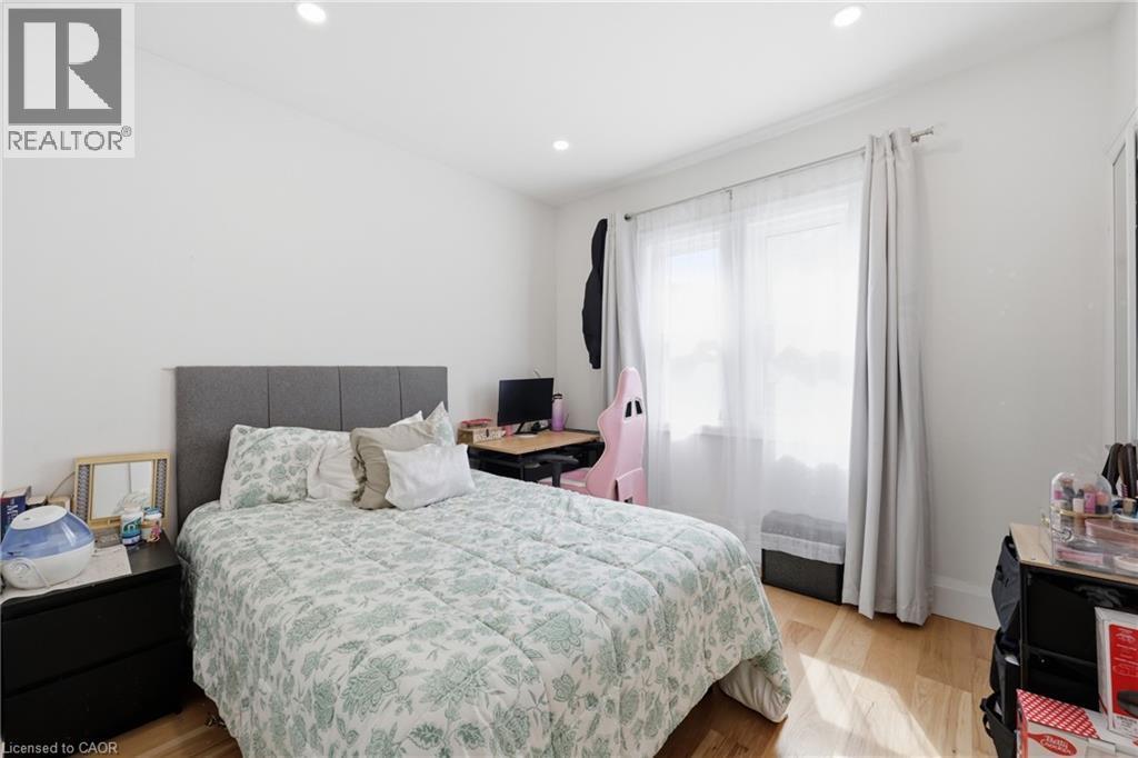 Bedroom featuring light wood-style floors and recessed lighting - 129 Jackson Street W, Hamilton, ON - Indoor Photo Showing Bedroom
