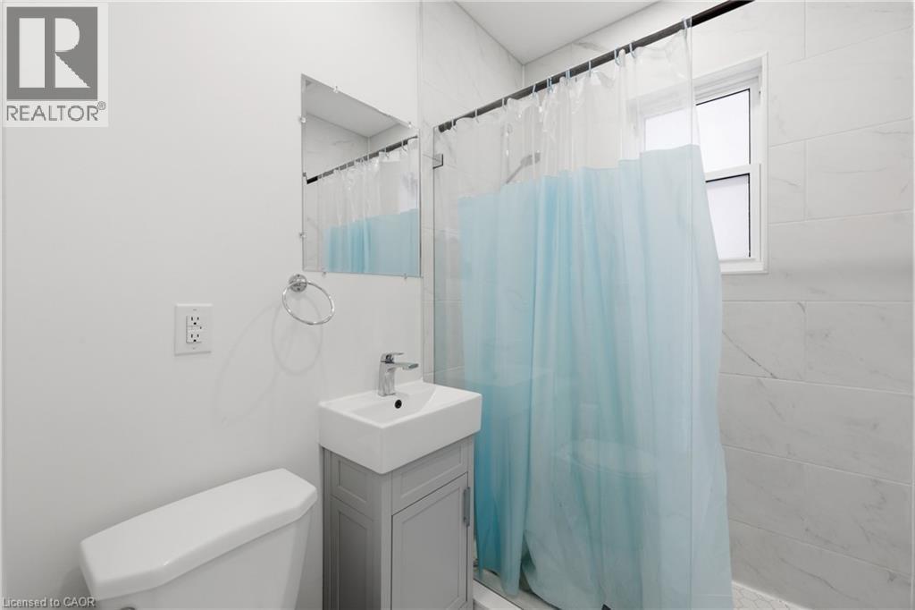 Bathroom with vanity and a stall shower - 129 Jackson Street W, Hamilton, ON - Indoor Photo Showing Bathroom