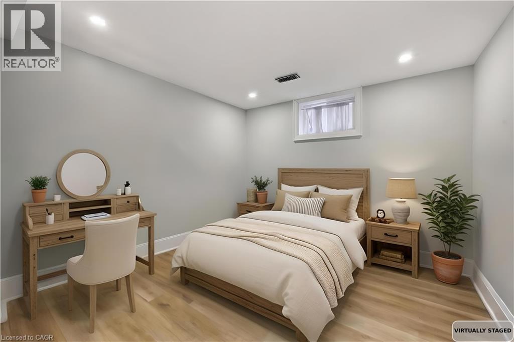 Bedroom with light wood-style floors and recessed lighting - 129 Jackson Street W, Hamilton, ON - Indoor Photo Showing Bedroom