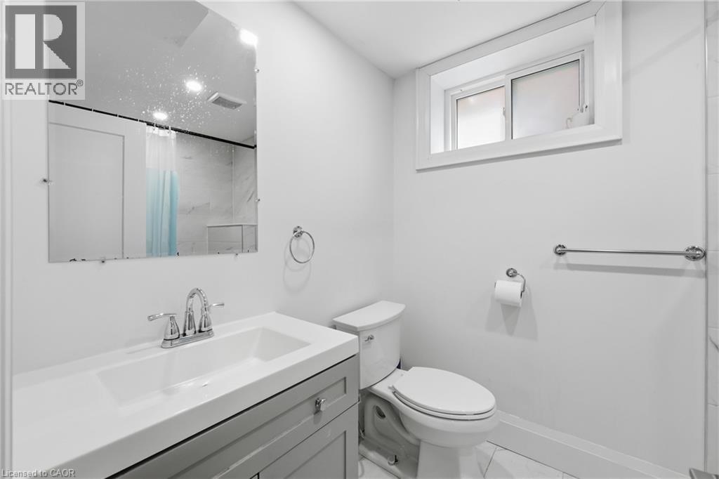 Full bathroom with vanity and a shower with shower curtain - 129 Jackson Street W, Hamilton, ON - Indoor Photo Showing Bathroom