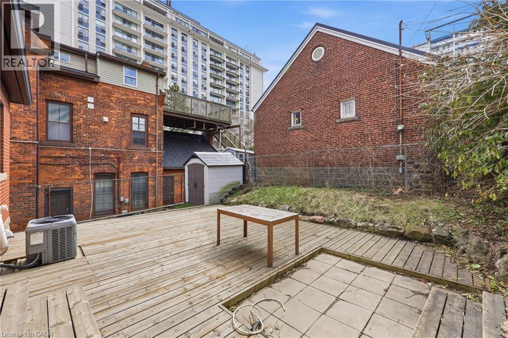 Wooden deck with a storage shed - 129 Jackson Street W, Hamilton, ON - Outdoor With Deck Patio Veranda With Exterior