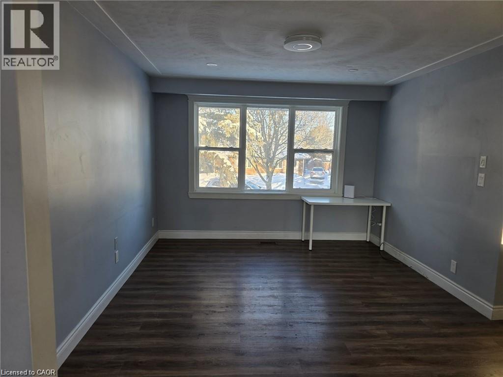 Unfurnished room featuring dark wood finished floors - 593 Mount Anne Drive, Waterloo, ON - Indoor Photo Showing Other Room