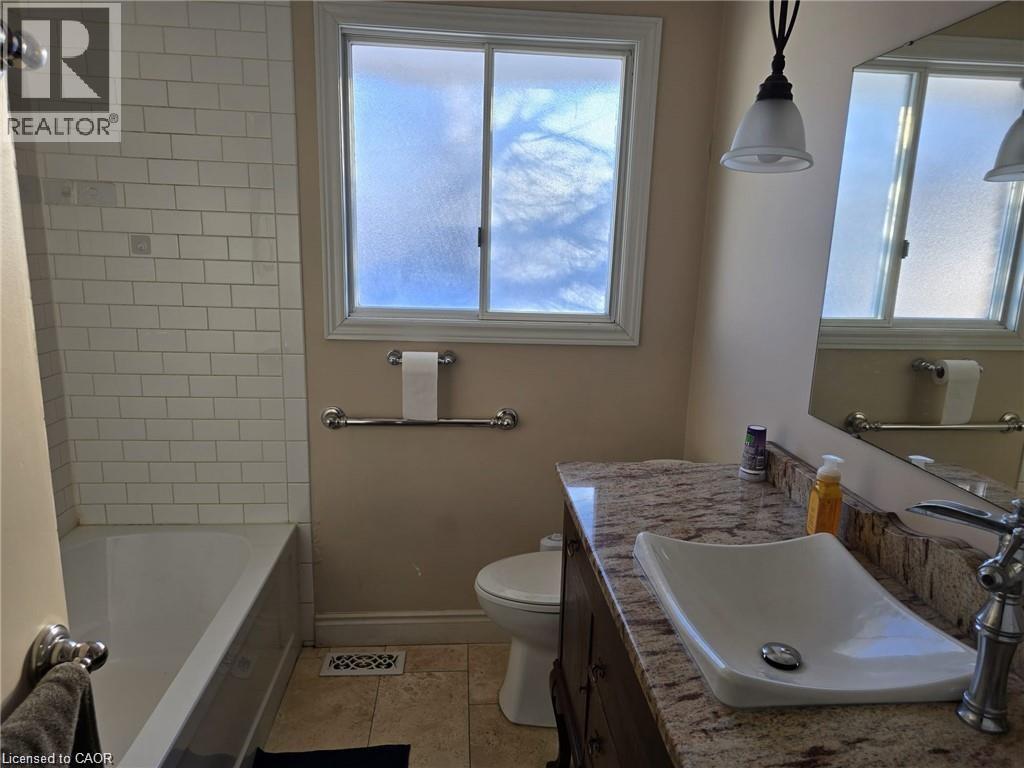 Bathroom featuring vanity, light tile patterned floors, and healthy amount of natural light - 593 Mount Anne Drive, Waterloo, ON - Indoor Photo Showing Bathroom