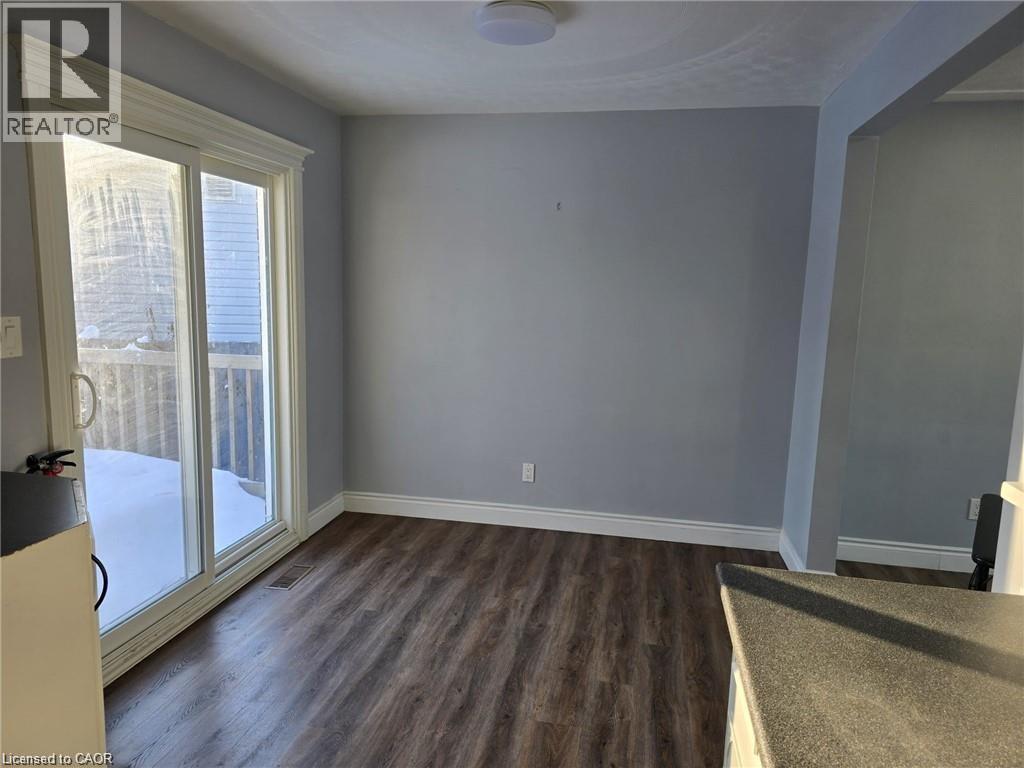 Spare room with dark wood-style flooring and baseboards - 593 Mount Anne Drive, Waterloo, ON - Indoor Photo Showing Other Room