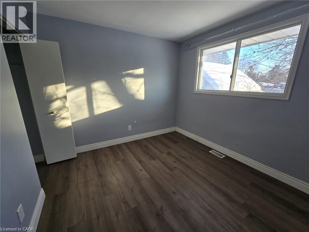 Spare room featuring dark wood finished floors and baseboards - 593 Mount Anne Drive, Waterloo, ON - Indoor Photo Showing Other Room