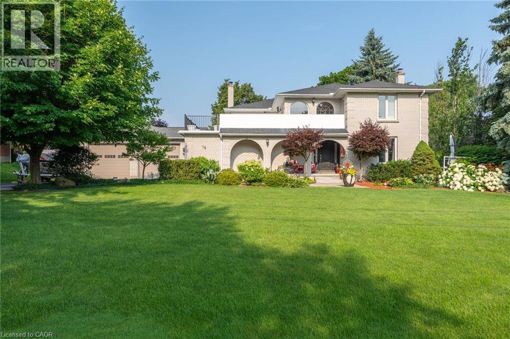 Mediterranean / spanish-style home featuring a chimney, brick siding, and a front yard - 15 Marquette Drive, Kitchener, ON - Outdoor