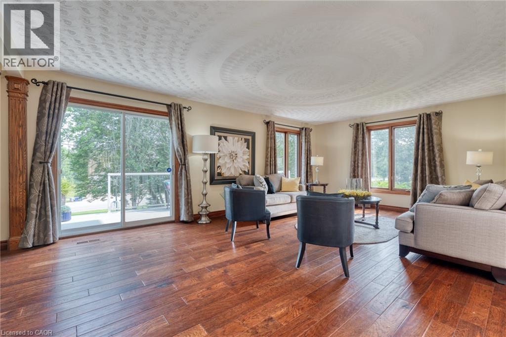 Living area featuring dark wood-style flooring and baseboards - 15 Marquette Drive, Kitchener, ON - Indoor Photo Showing Living Room