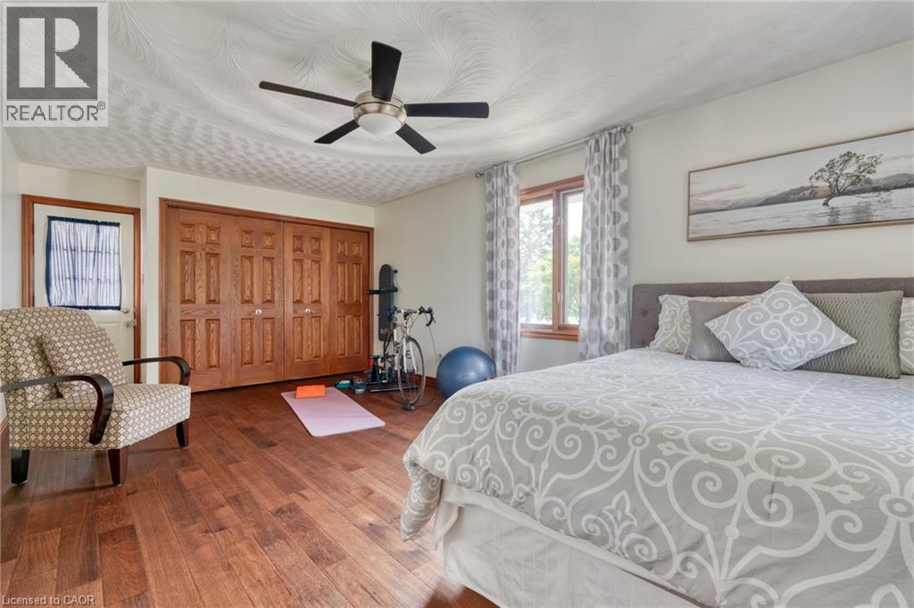 Bedroom featuring dark wood finished floors, ceiling fan, and a closet - 15 Marquette Drive, Kitchener, ON - Indoor Photo Showing Bedroom