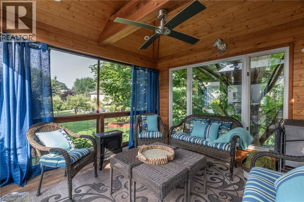 Sunroom with ceiling fan, vaulted ceiling with beams, and an outdoor lounge area - 15 Marquette Drive, Kitchener, ON - With Exterior