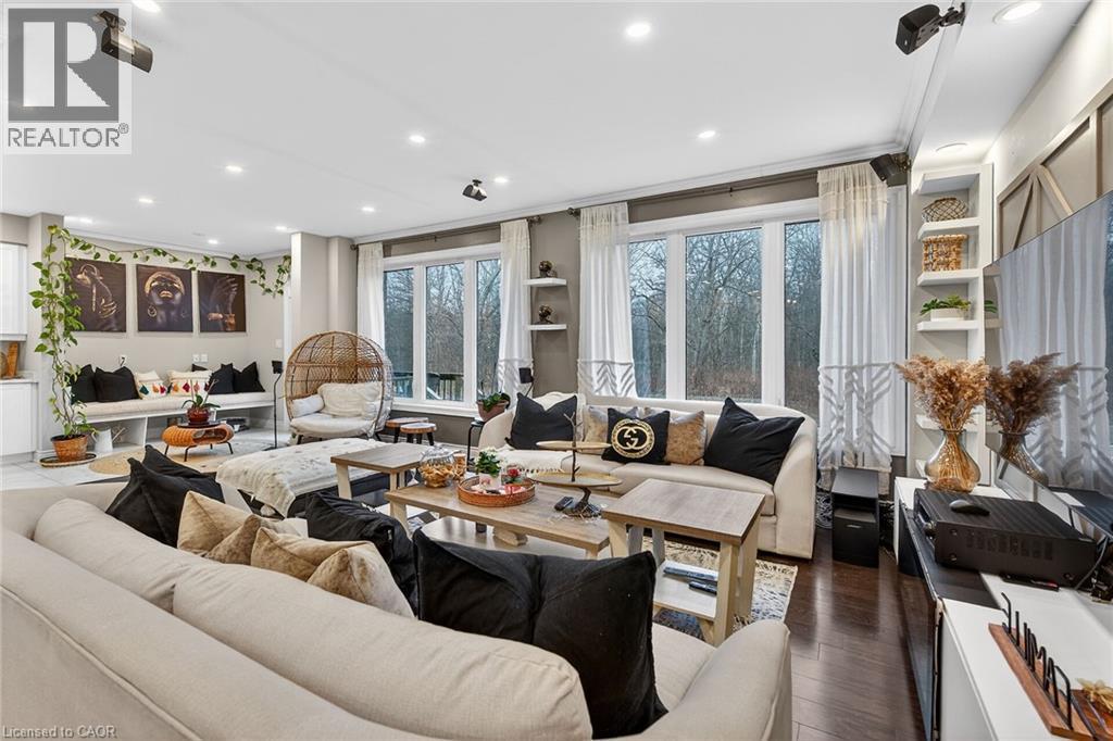 Living area featuring dark wood-style flooring and recessed lighting - 7809 Hackberry Trail E, Niagara Falls, ON - Indoor Photo Showing Living Room