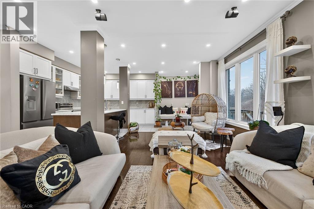 Living area with dark wood-type flooring and recessed lighting - 7809 Hackberry Trail E, Niagara Falls, ON - Indoor Photo Showing Living Room
