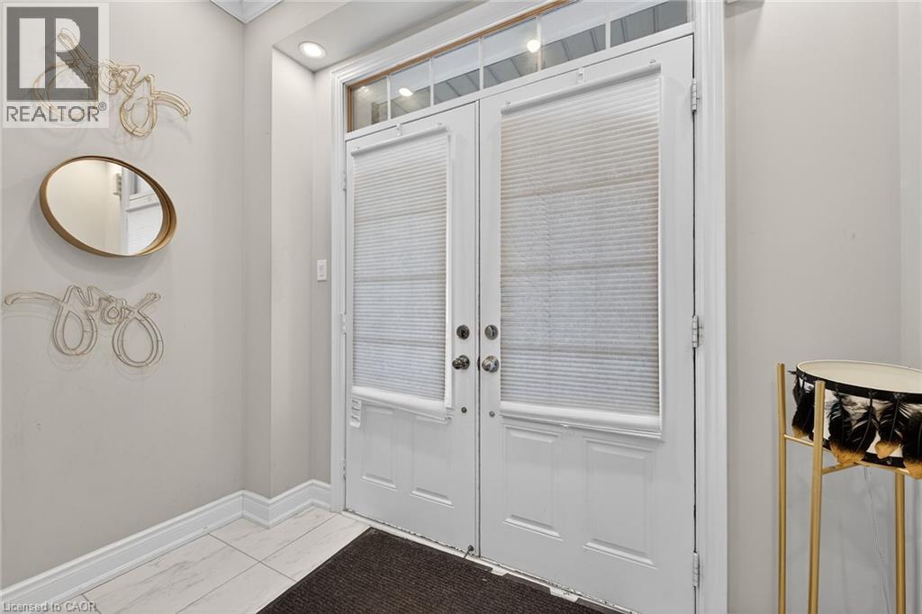 Doorway to outside featuring baseboards and french doors - 7809 Hackberry Trail E, Niagara Falls, ON - Indoor Photo Showing Other Room