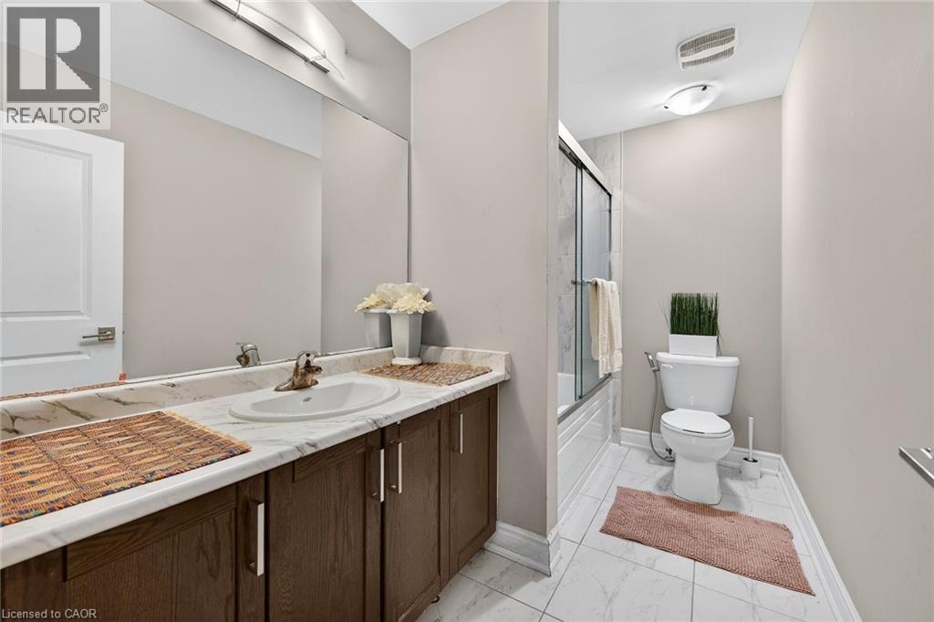 Bathroom with vanity, bath / shower combo with glass door, and light marble finish flooring - 7809 Hackberry Trail E, Niagara Falls, ON - Indoor Photo Showing Bathroom