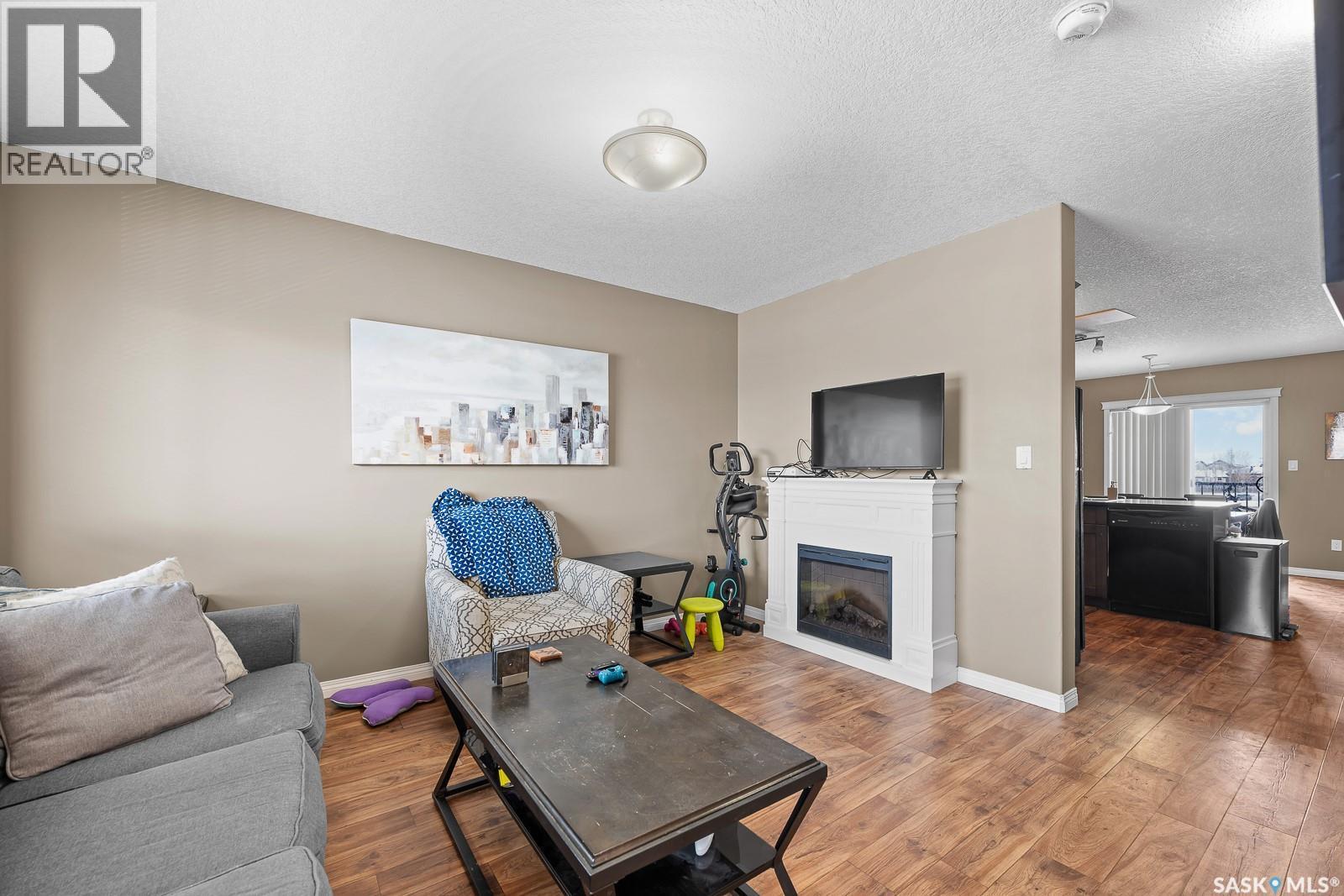411 3826 Dewdney Avenue E, Regina, SK - Indoor Photo Showing Living Room With Fireplace