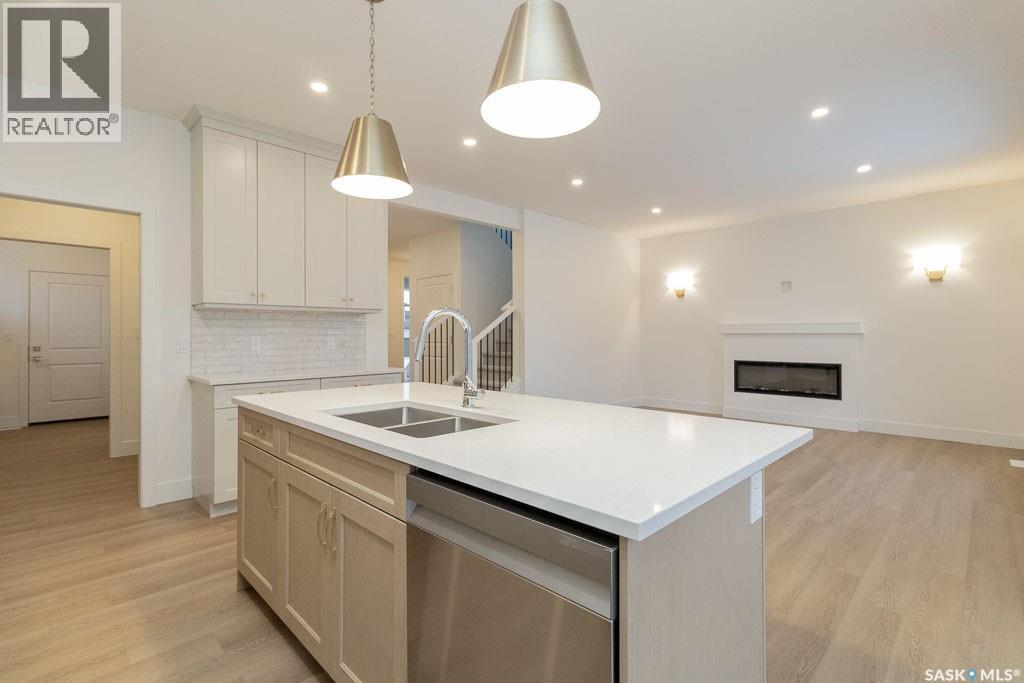 150 Mazurek Crescent, Saskatoon, SK - Indoor Photo Showing Kitchen With Fireplace With Double Sink