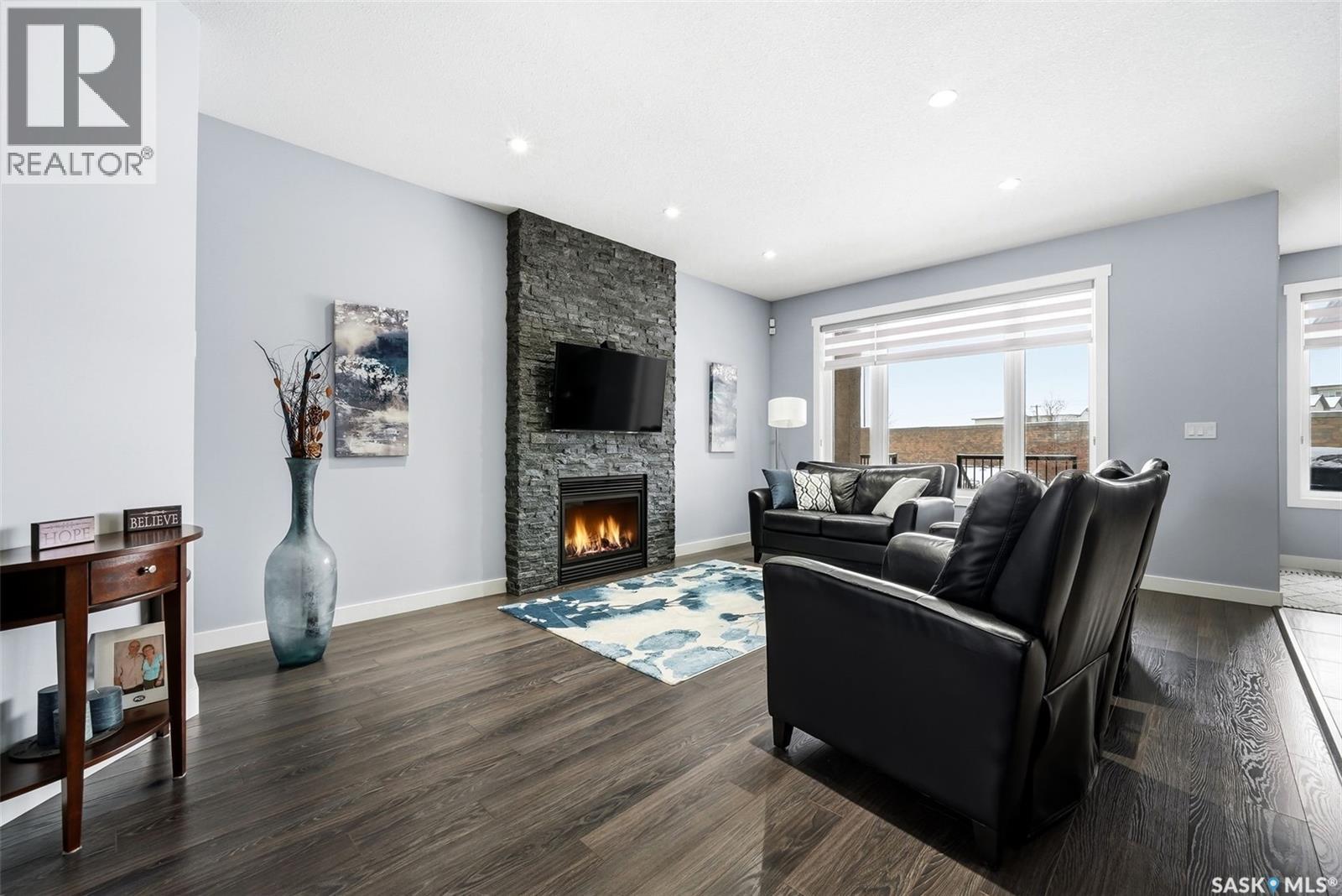 3921 Red Lily Bay, Regina, SK - Indoor Photo Showing Living Room With Fireplace