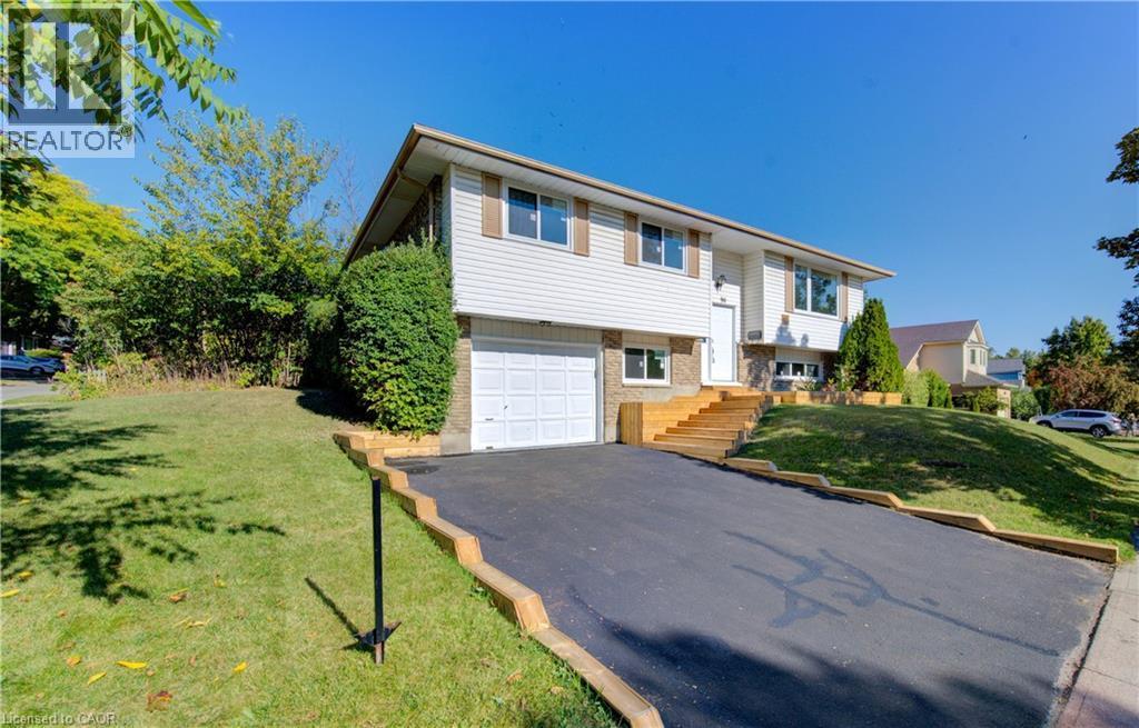 Split foyer home with brick siding, asphalt driveway, a front yard, and an attached garage - 90 Culpepper Drive, Waterloo, ON - Outdoor