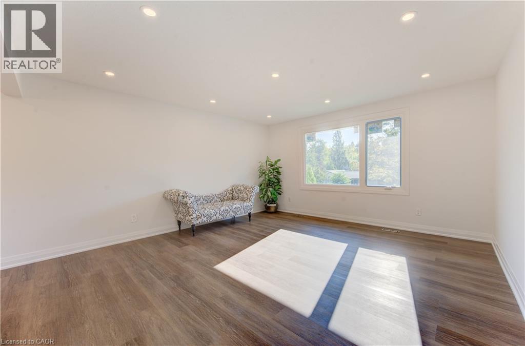 Living area featuring recessed lighting and wood finished floors - 90 Culpepper Drive, Waterloo, ON - Indoor Photo Showing Other Room
