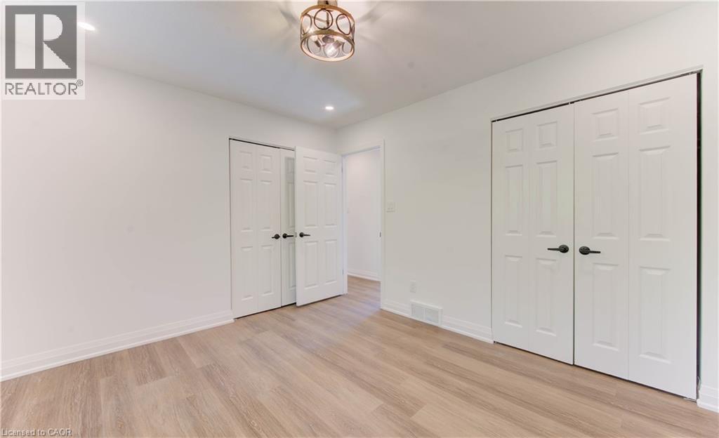 Unfurnished bedroom featuring light wood finished floors, two closets, and recessed lighting - 90 Culpepper Drive, Waterloo, ON - Indoor Photo Showing Other Room