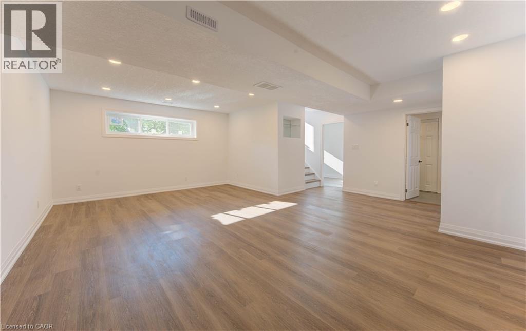 Spare room with recessed lighting, light wood finished floors, and stairway - 90 Culpepper Drive, Waterloo, ON - Indoor Photo Showing Other Room