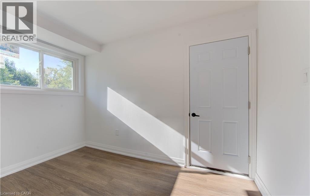Unfurnished room with light wood-style flooring and baseboards - 90 Culpepper Drive, Waterloo, ON - Indoor Photo Showing Other Room