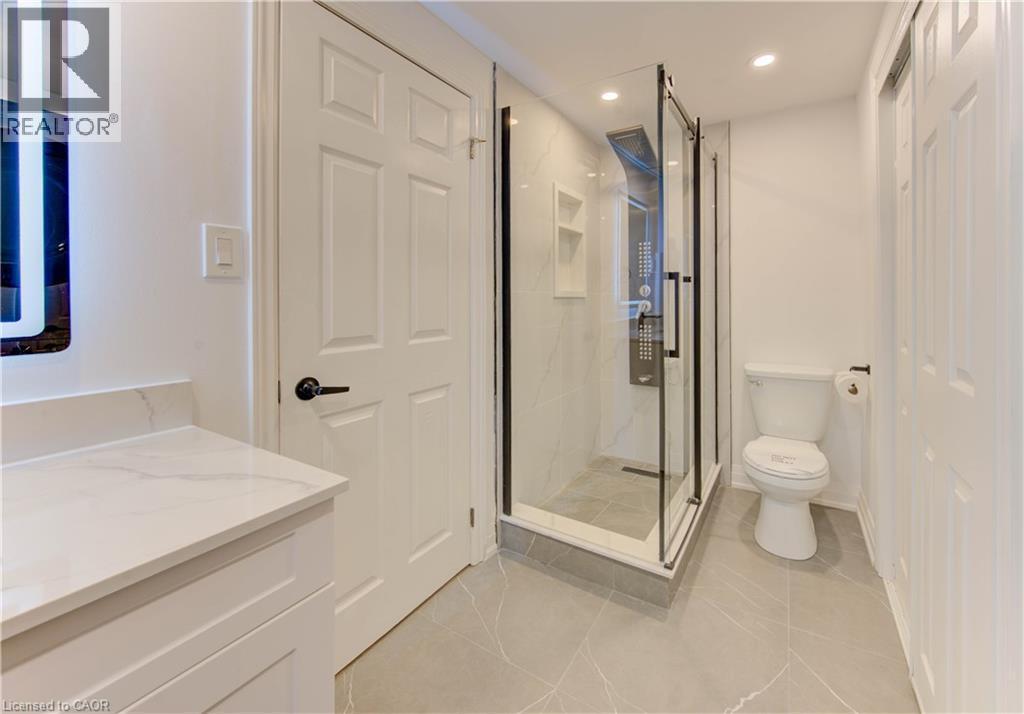 Full bathroom featuring a marble finish shower, light tile patterned flooring, vanity, and recessed lighting - 90 Culpepper Drive, Waterloo, ON - Indoor Photo Showing Bathroom