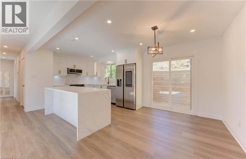 Kitchen featuring white cabinets, stainless steel appliances, recessed lighting, pendant lighting, and light wood-type flooring - 90 Culpepper Drive, Waterloo, ON - Indoor Photo Showing Kitchen
