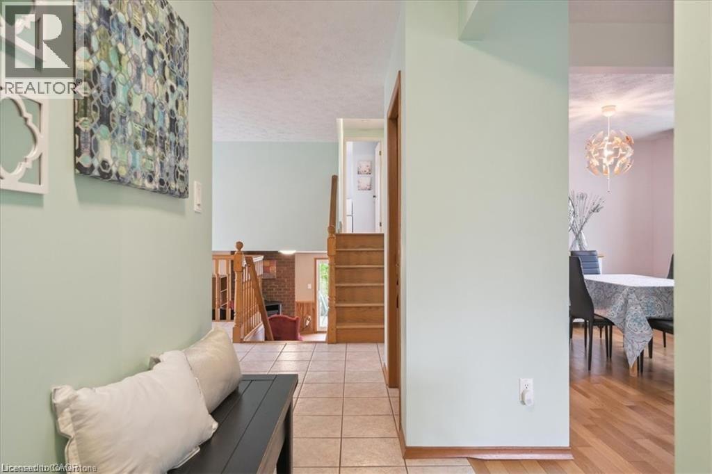 Hall with suspended lighting, light tile patterned floors, and a textured ceiling - 47 Claycroft Crescent Unit# Upper, Kitchener, ON - Indoor Photo Showing Other Room