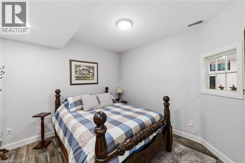 In-law bedroom 1 of 2 with recessed lighting and walk-in closet, grey laminate flooring - 515 Hamilton Drive, Ancaster, ON - Indoor Photo Showing Bedroom