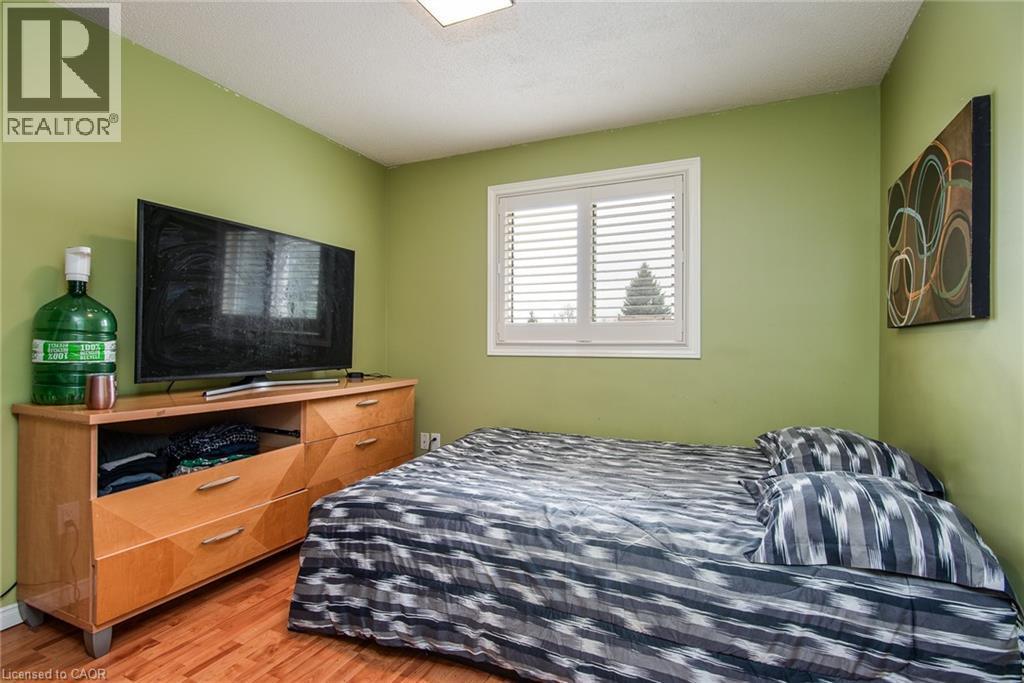 Bedroom featuring light wood-style floors and a textured ceiling - 236 Dartmoor Crescent, Waterloo, ON - Indoor Photo Showing Bedroom