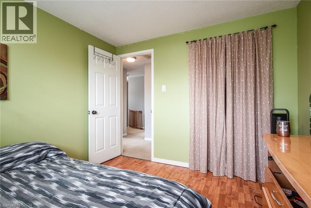 Bedroom featuring a textured ceiling and light wood-type flooring - 236 Dartmoor Crescent, Waterloo, ON - Indoor Photo Showing Bedroom