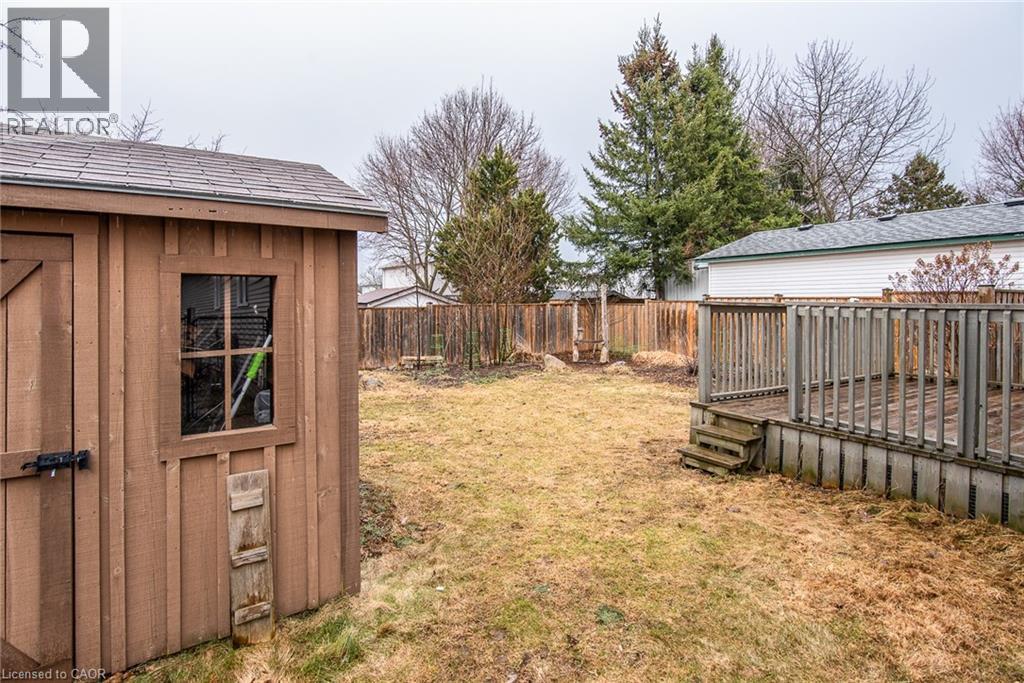 Fenced backyard featuring a wooden deck and a storage shed - 236 Dartmoor Crescent, Waterloo, ON - Outdoor