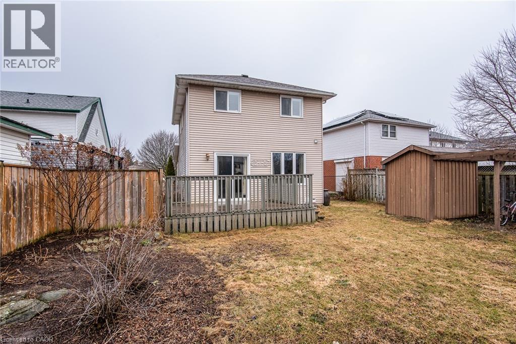 Back of property featuring a fenced backyard, a storage unit, and a wooden deck - 236 Dartmoor Crescent, Waterloo, ON - Outdoor With Exterior