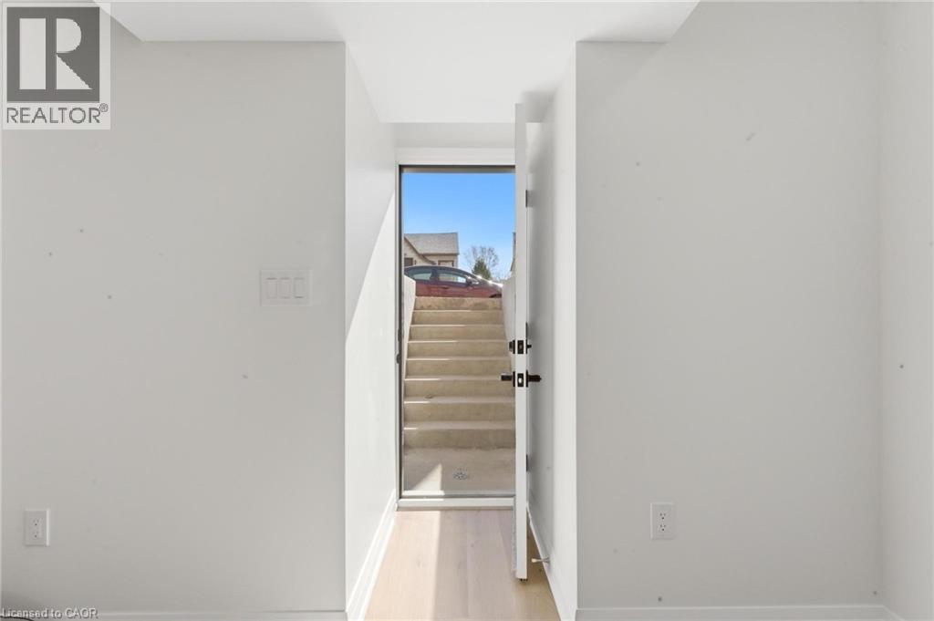 Staircase with wood finished floors and baseboards - 187 Oak Avenue Unit# Lower, Hamilton, ON - Indoor Photo Showing Other Room