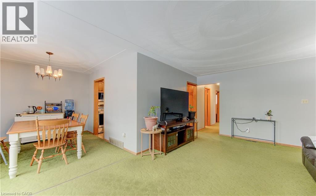 Dining space featuring a chandelier and light colored carpet - 98 Shea Crescent, Kitchener, ON - Indoor Photo Showing Other Room