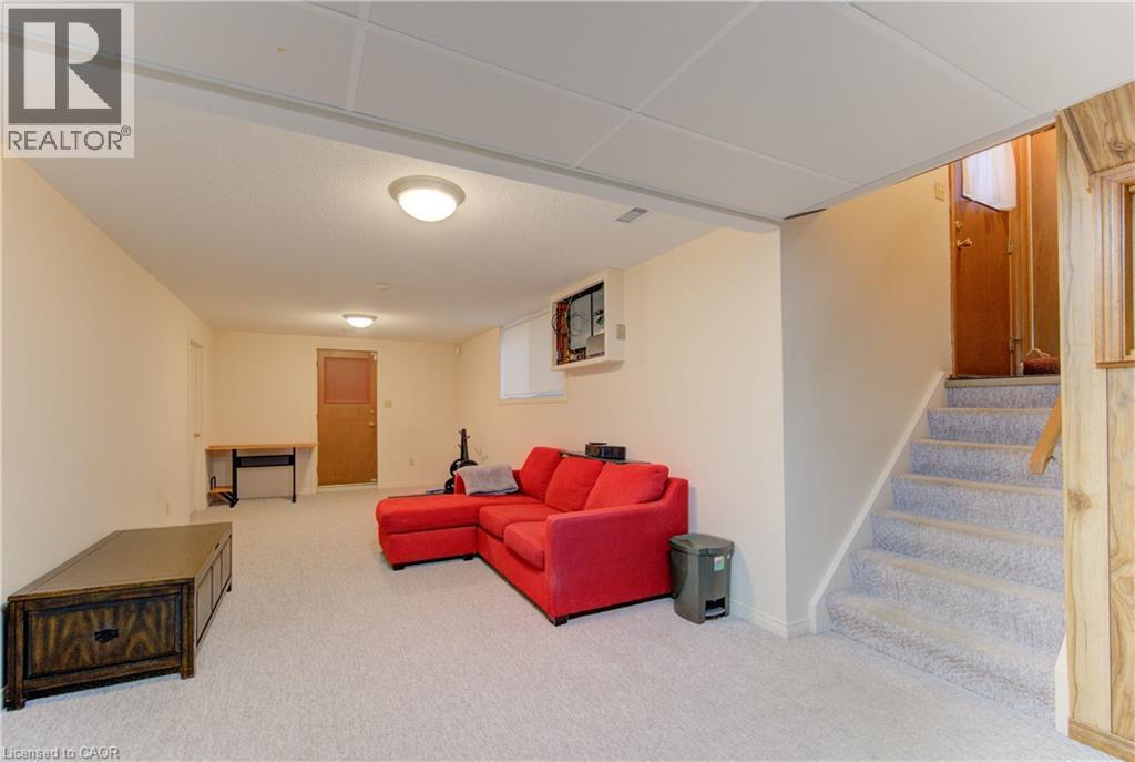 Living area featuring stairway and light colored carpet - 98 Shea Crescent, Kitchener, ON - Indoor
