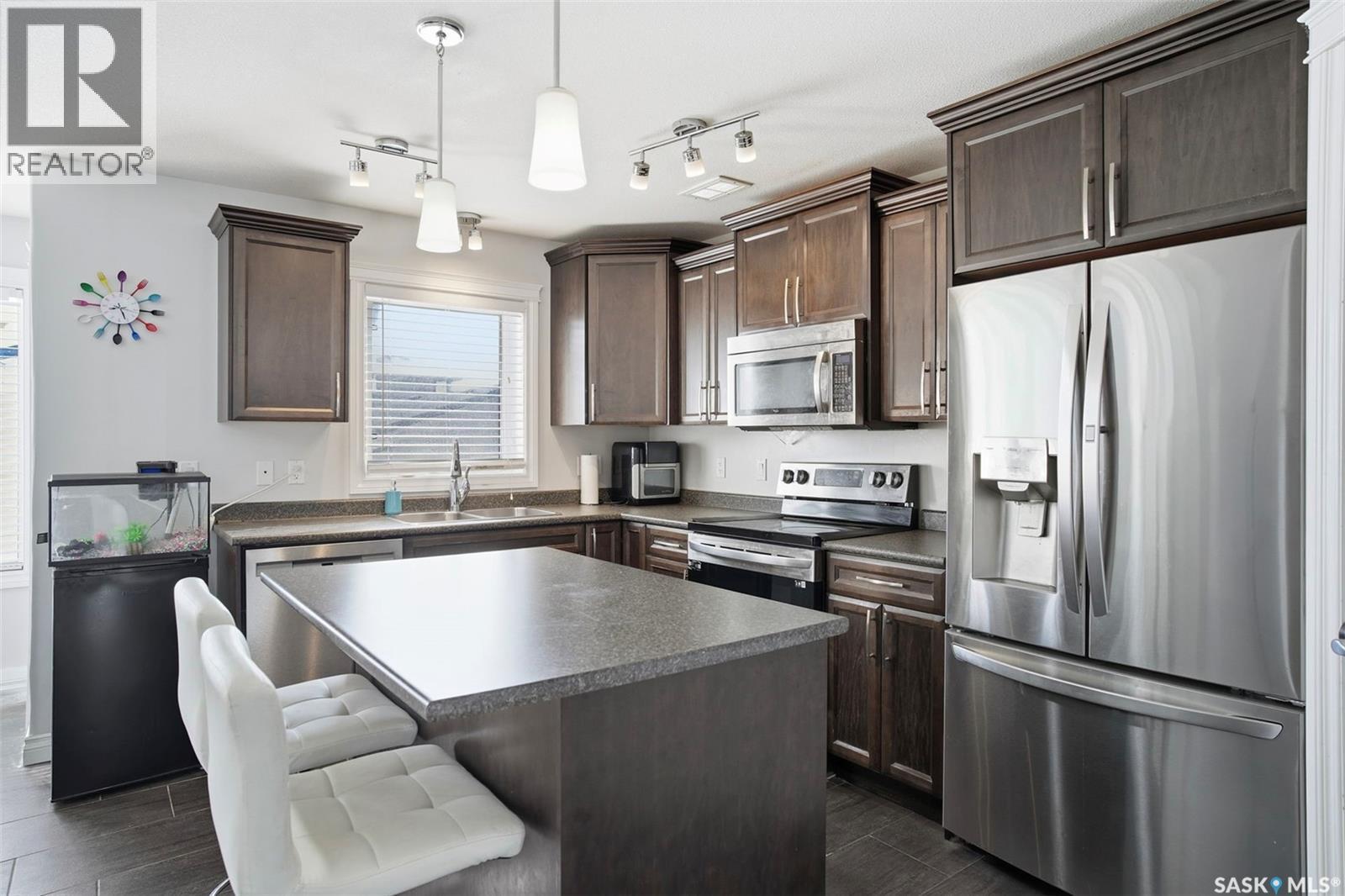 215 Wyant Lane, Saskatoon, SK - Indoor Photo Showing Kitchen With Double Sink