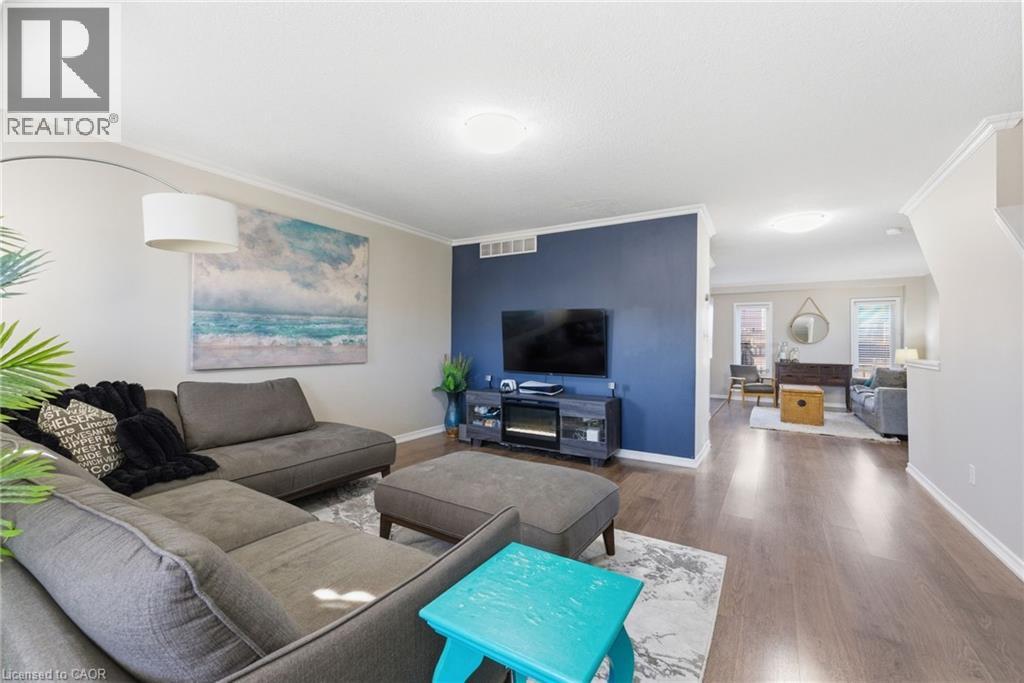 Living room featuring wood finished floors and crown molding - 208 Templewood Drive, Kitchener, ON - Indoor Photo Showing Living Room