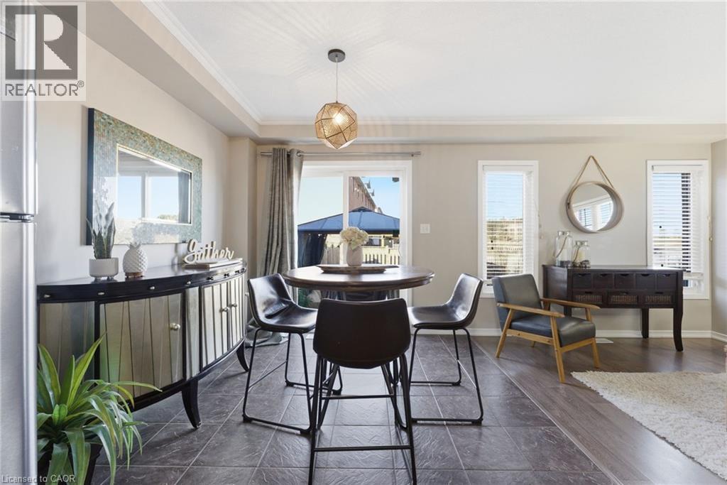 Dining space with a tray ceiling, crown molding, and dark wood-style flooring - 208 Templewood Drive, Kitchener, ON - Indoor Photo Showing Dining Room