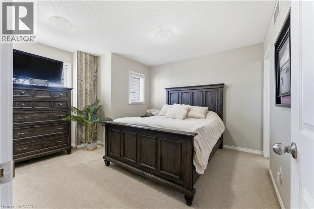 Bedroom featuring light carpet and a textured ceiling - 208 Templewood Drive, Kitchener, ON - Indoor Photo Showing Bedroom