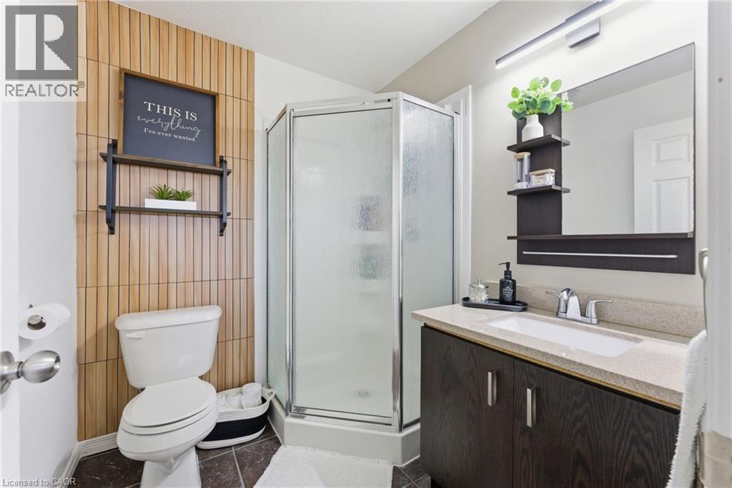 Full bath featuring vanity, a stall shower, and dark tile patterned floors - 208 Templewood Drive, Kitchener, ON - Indoor Photo Showing Bathroom