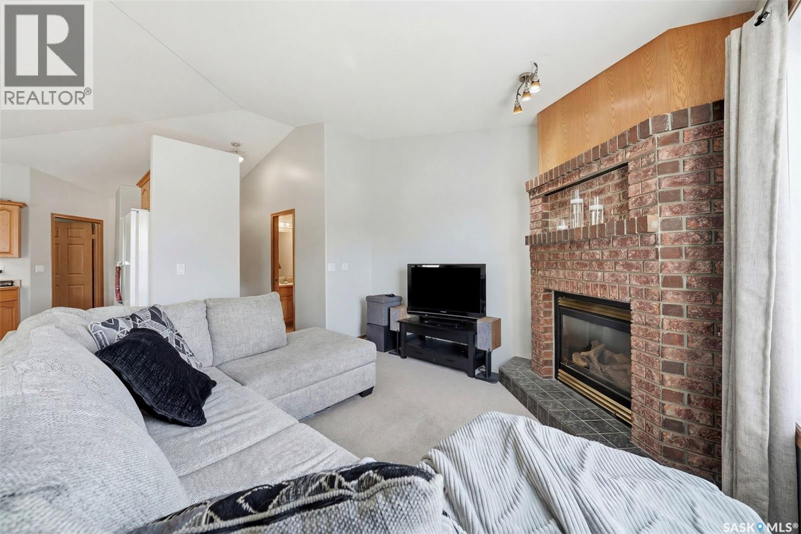 11 Columbia Drive, Saskatoon, SK - Indoor Photo Showing Living Room With Fireplace