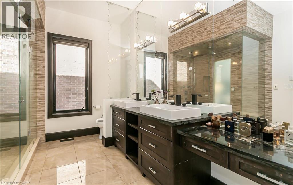 Bathroom featuring double vanity, a stall shower, and light tile patterned floors - 24 Jacob Gingrich Drive, Kitchener, ON - Indoor Photo Showing Bathroom